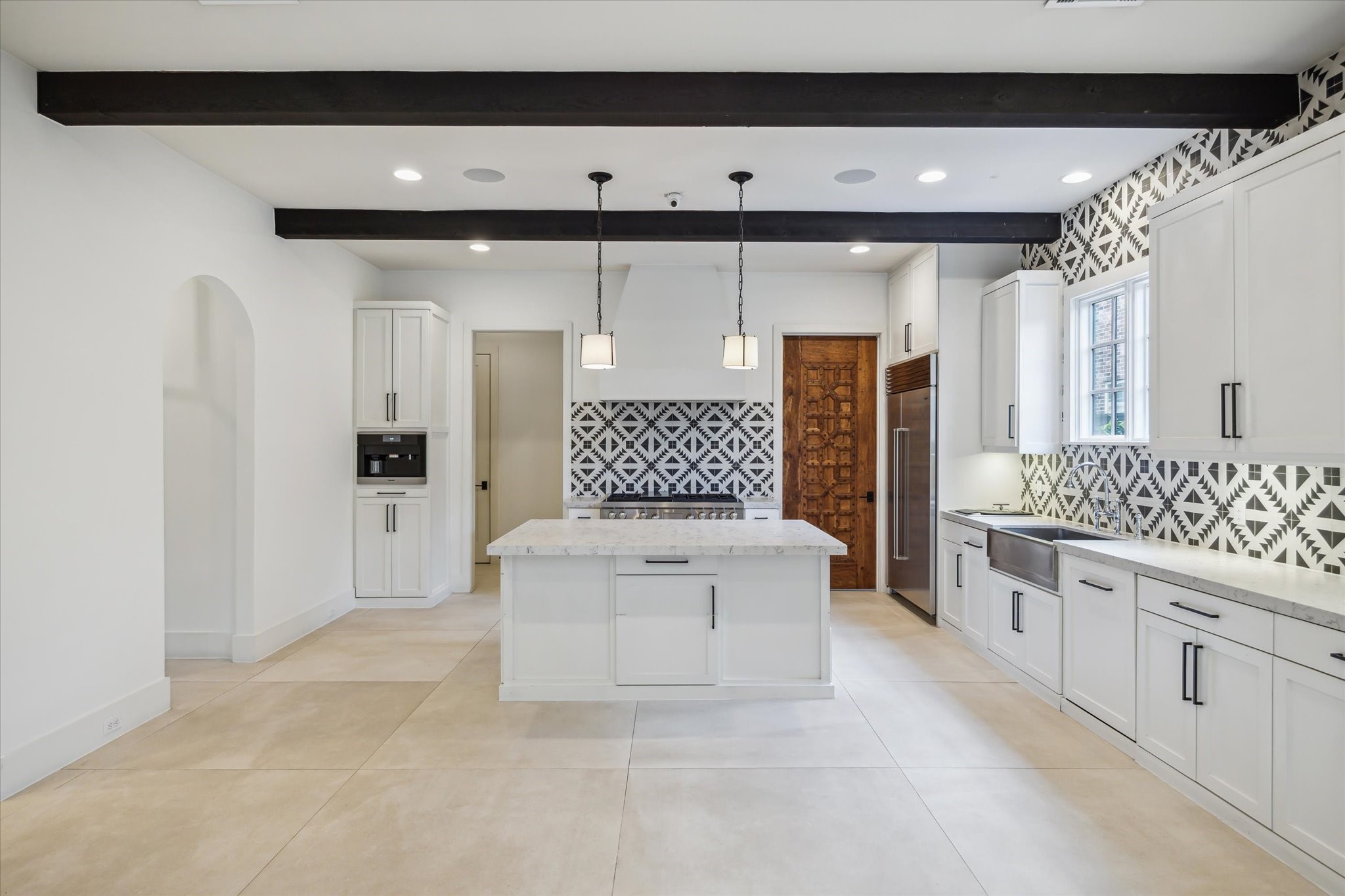 3214 Westheimer Road Houston, TX 77098 - Photo 14 of 39 The chef’s kitchen combines style and practicality with quartz countertops, a six-burner Wolf range, and a stainless steel apron sink. It’s a culinary dream space designed for both function and elegance.