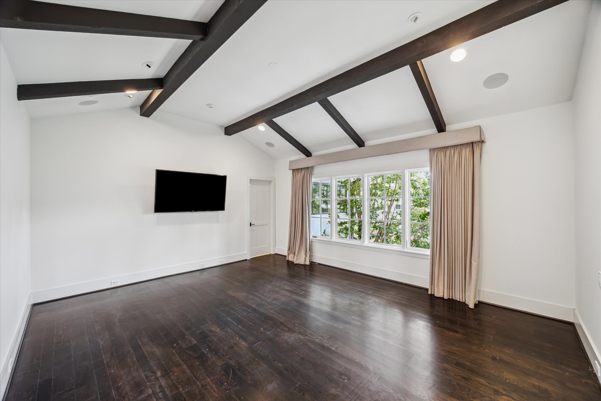 3214 Westheimer Road Houston, TX 77098 - Photo 22 of 39 In-ceiling speakers and an elegant chandelier add to the room’s sophisticated ambiance. The primary suite is truly a haven of tranquility and style.