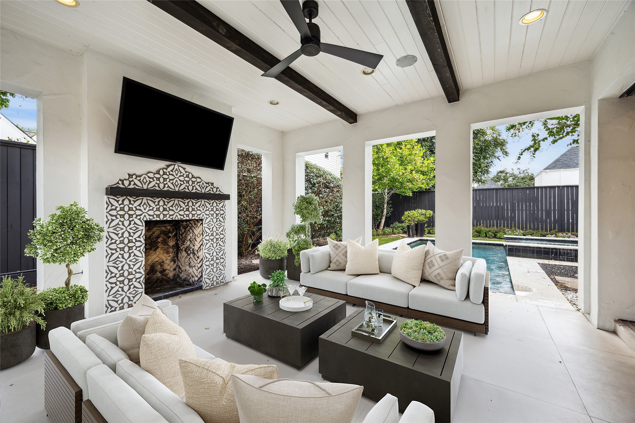 3214 Westheimer Road Houston, TX 77098 - Photo 10 of 39 The fully equipped summer kitchen, complete with a Wolf grill, is perfect for hosting gatherings of all sizes. The covered patio, featuring a gas and wood-burning fireplace, creates a cozy ambiance for outdoor entertaining in any season. *Virtually rendered*