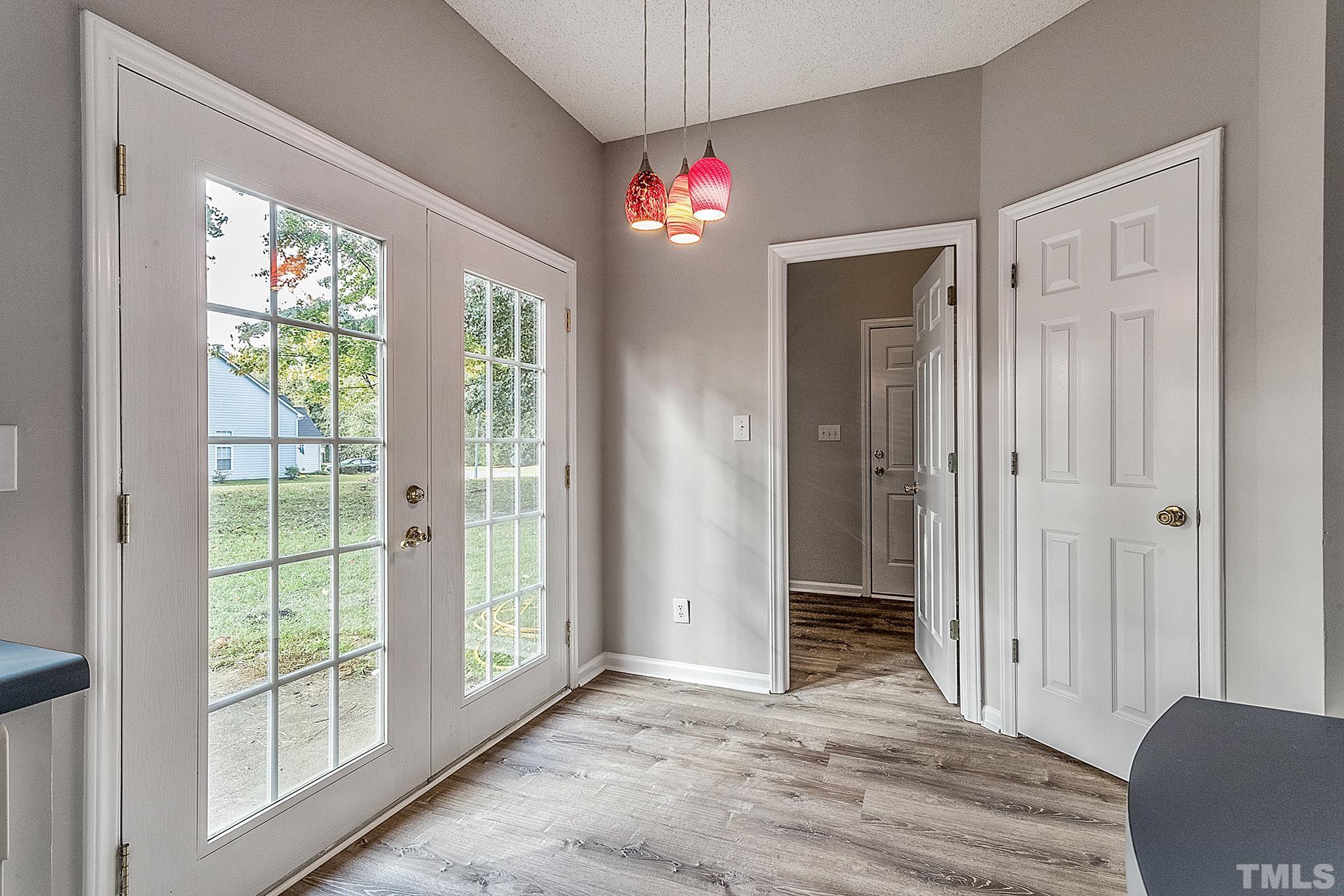 121 Marleton Way Holly Springs, NC 27540 - Photo 15 of 26 a view of an empty room with wooden floor and a window