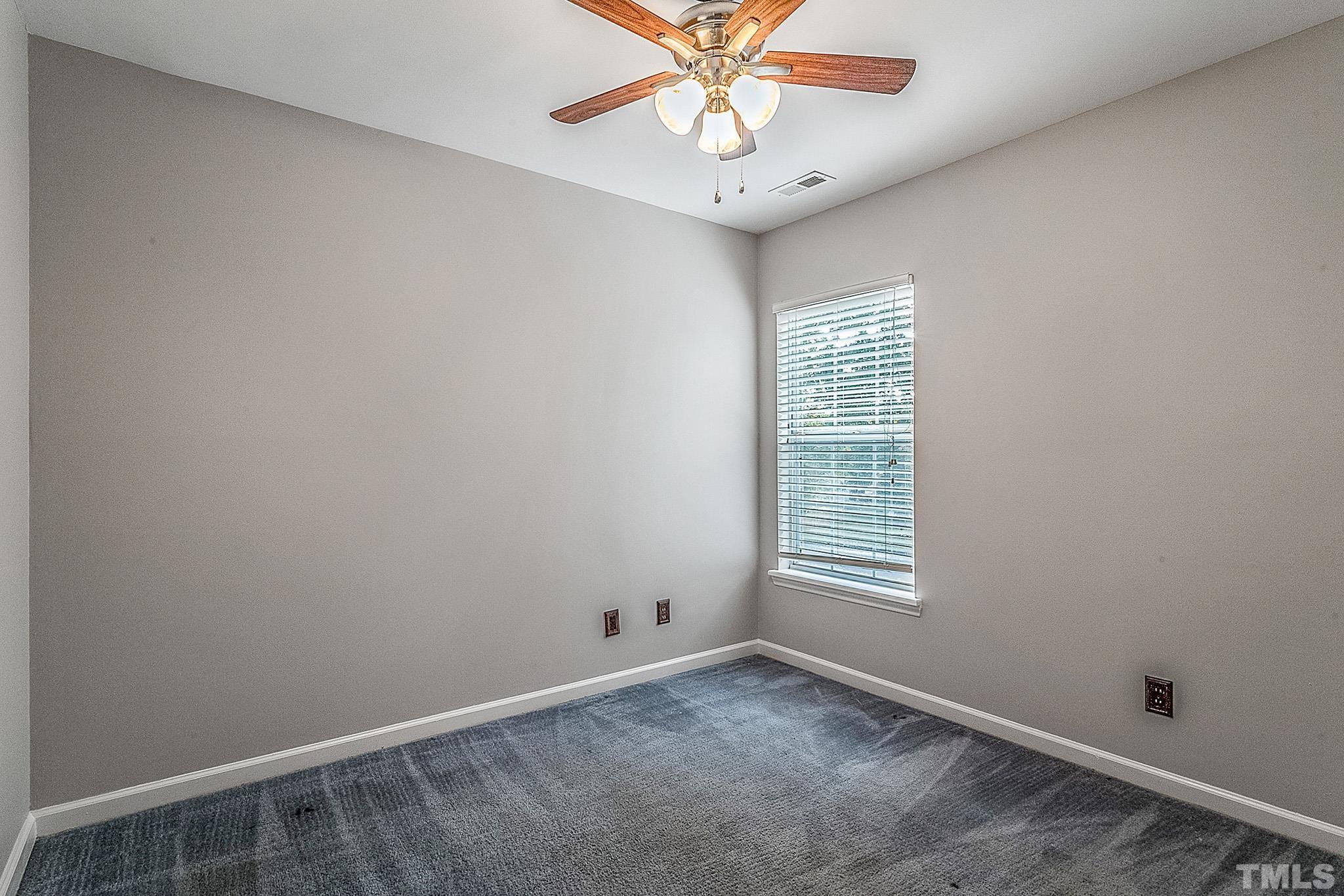 121 Marleton Way Holly Springs, NC 27540 - Photo 23 of 26 a view of an empty room with a window