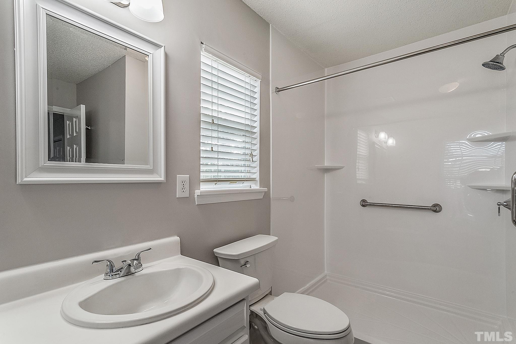 121 Marleton Way Holly Springs, NC 27540 - Photo 25 of 26 a bathroom with a sink a toilet and shower
