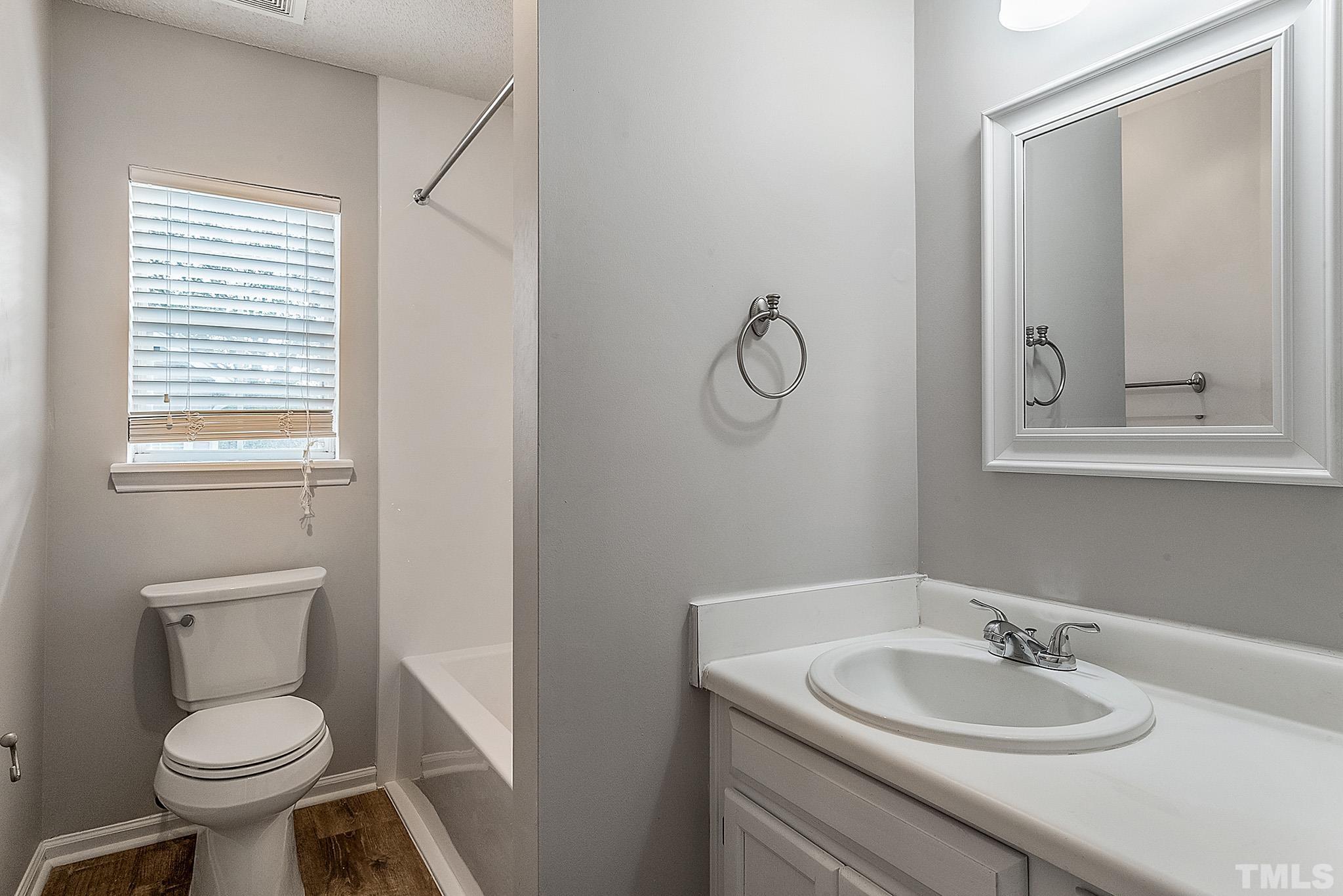 121 Marleton Way Holly Springs, NC 27540 - Photo 26 of 26 a bathroom with a toilet sink and mirror