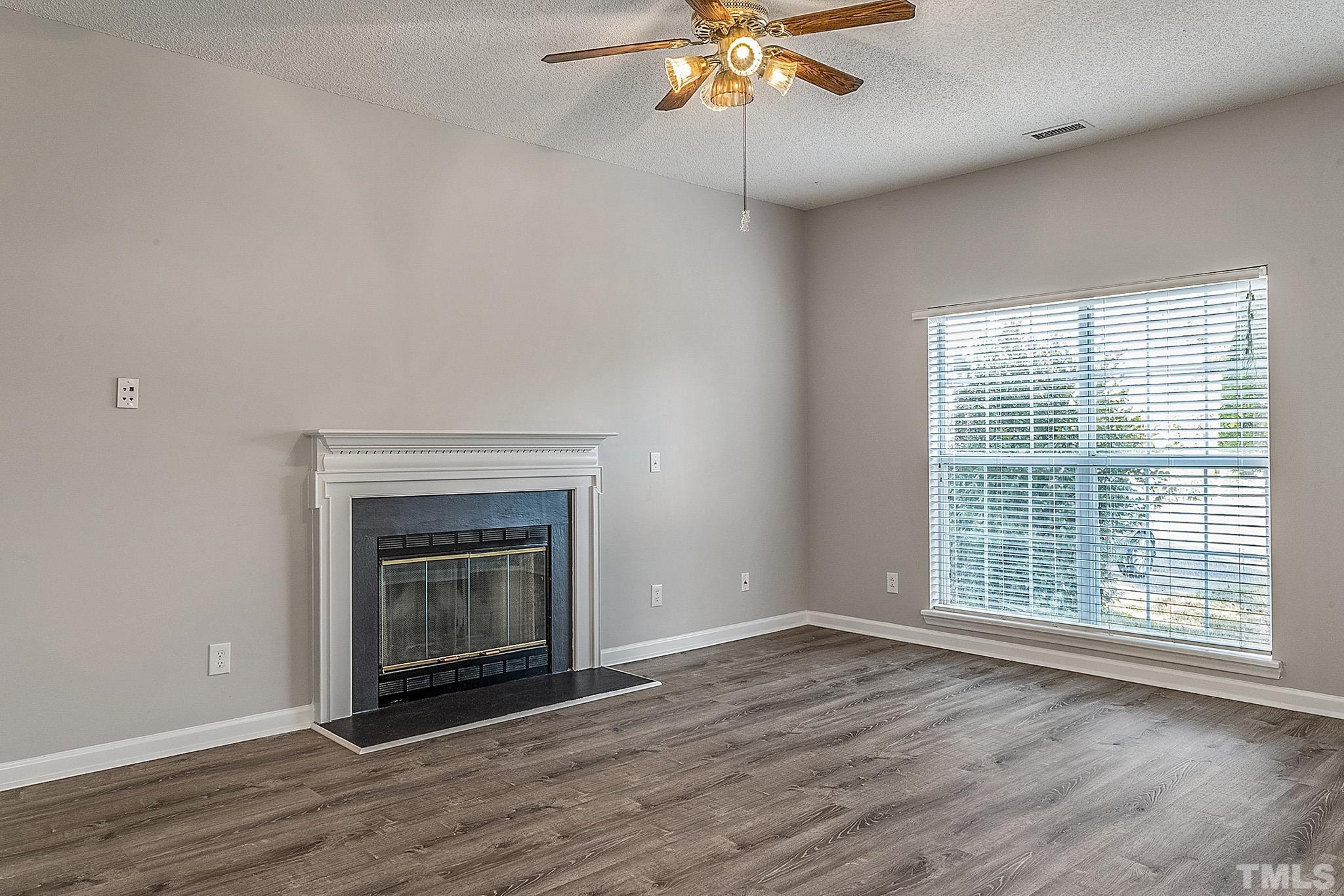 121 Marleton Way Holly Springs, NC 27540 - Photo 7 of 26 a view of an empty room with wooden floor and a window