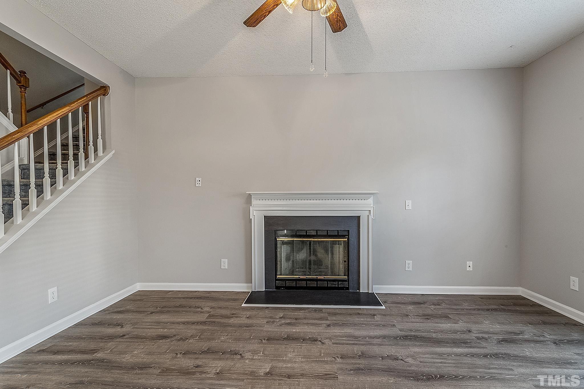 121 Marleton Way Holly Springs, NC 27540 - Photo 8 of 26 a view of empty room with wooden floor and fireplace