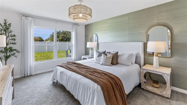 a bed room with a bed and a chair