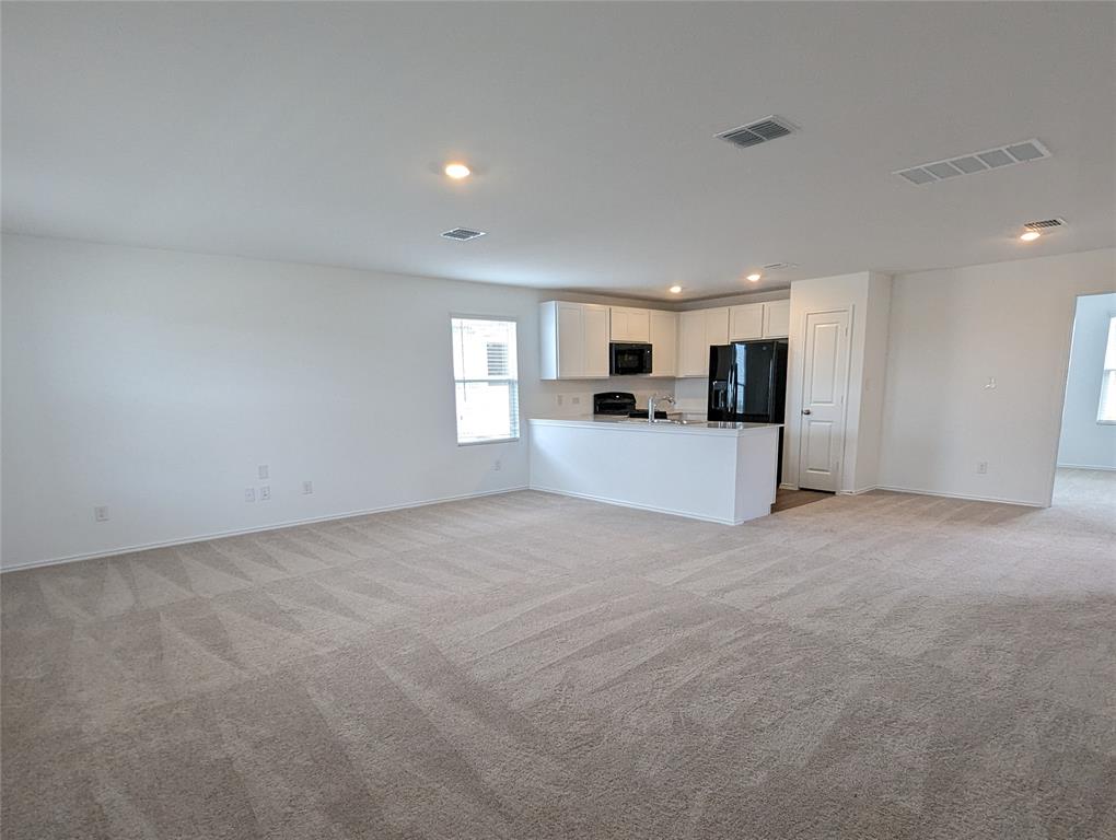 152 Avre Loop Kyle, TX 78640 - Photo 23 of 24 An open floorplan seamlessly connects the living area with a well-appointed kitchen.