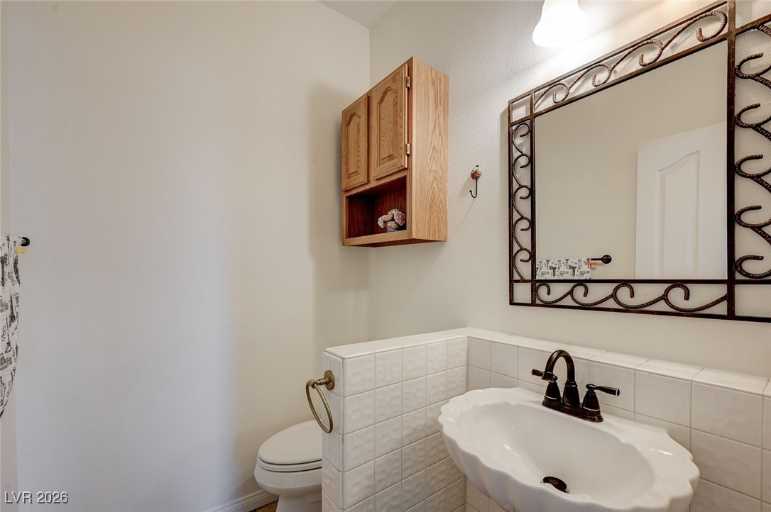 2955 El Camino Road Las Vegas, NV 89146 - Photo 34 of 99 Bathroom featuring a sink and tile walls