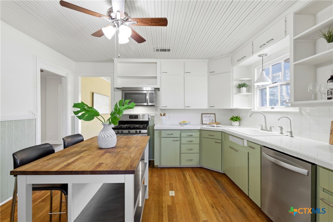 1506 Grace Street Taylor, TX 76574 - Photo 12 of 22 a kitchen with a sink window and cabinets