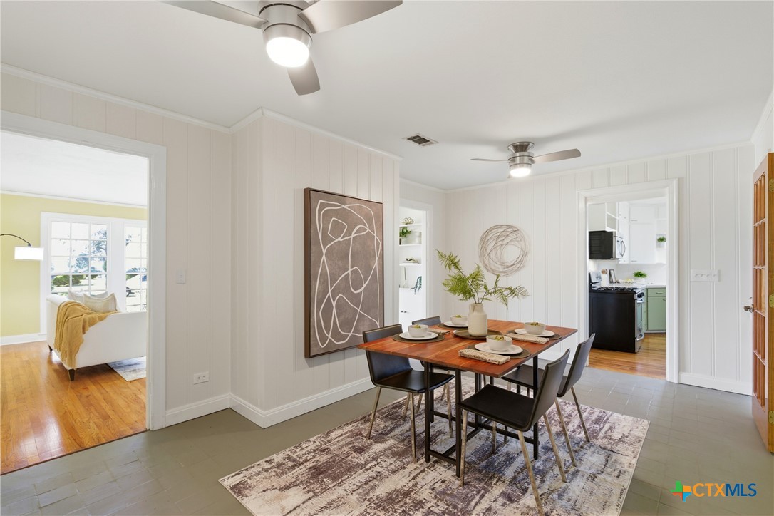 1506 Grace Street Taylor, TX 76574 - Photo 14 of 22 a view of a dining room with furniture and wooden floor