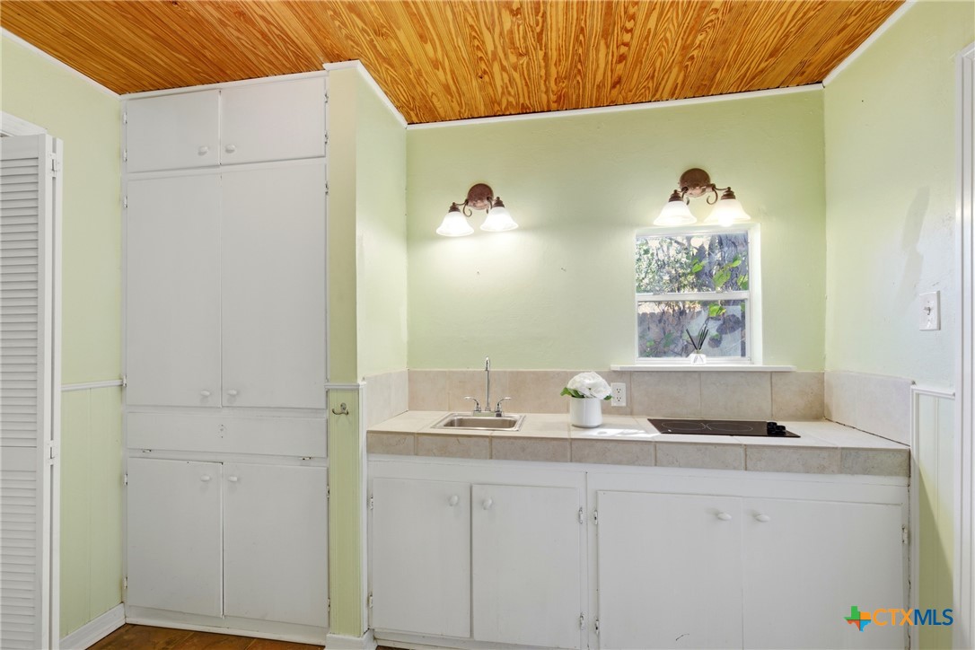 1506 Grace Street Taylor, TX 76574 - Photo 18 of 22 a bathroom with a granite countertop sink and a window