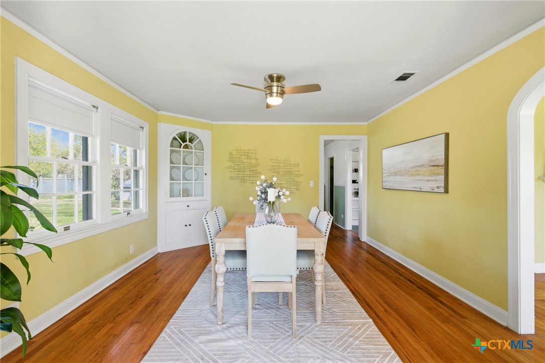 1506 Grace Street Taylor, TX 76574 - Photo 3 of 22 a dining room with furniture a chandelier and wooden floor