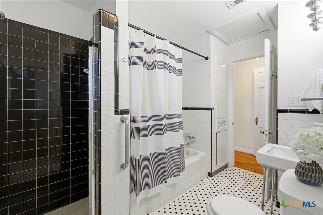 1506 Grace Street Taylor, TX 76574 - Photo 7 of 22 a bathroom with a sink toilet and shower