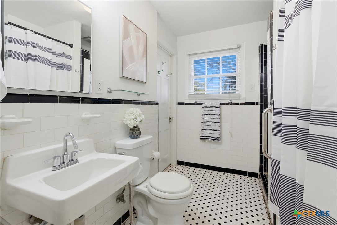1506 Grace Street Taylor, TX 76574 - Photo 8 of 22 a bathroom with a sink toilet and shower