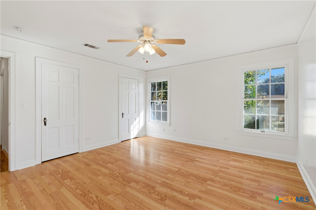 1506 Grace Street Taylor, TX 76574 - Photo 10 of 22 a view of an empty room with wooden floor and a window