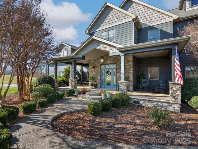 a front view of a house with garden and porch