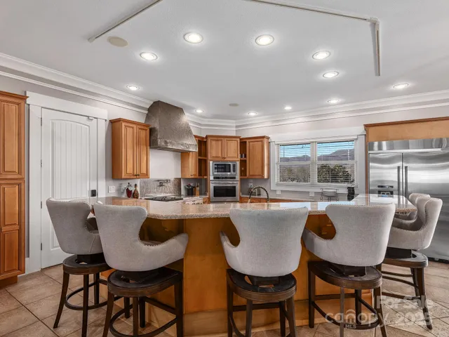 a dining area with furniture and a large window