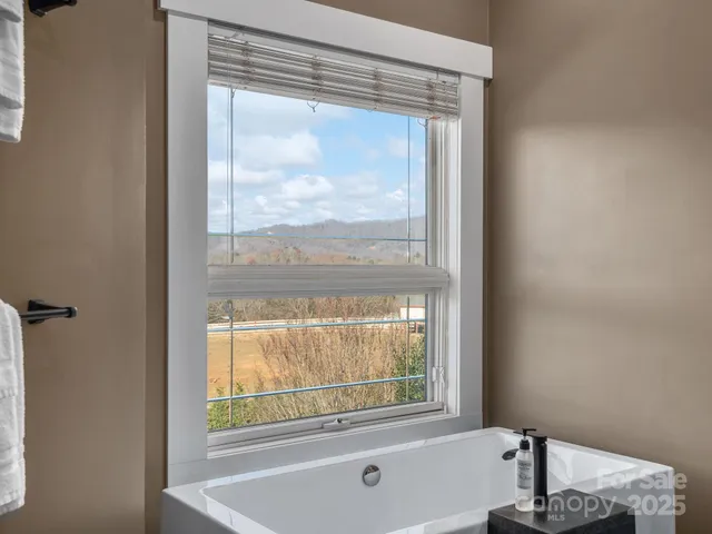 a bathroom with a bathtub and window
