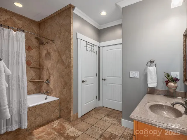 a bathroom with a granite countertop sink a mirror and shower