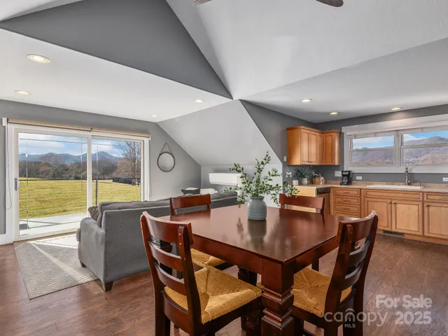 a dining room with furniture window and wooden floor