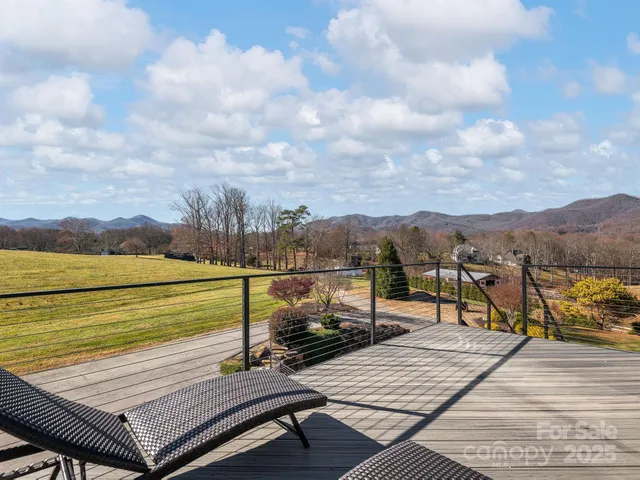a view of a terrace with wooden floor and lake view