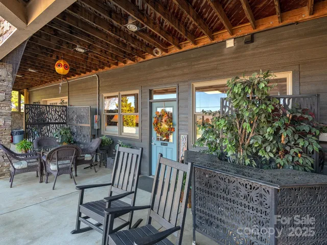 a view of a porch with dining table and chairs with potted plants