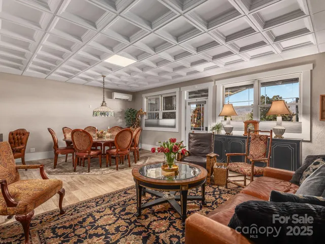 a living room with furniture and a chandelier