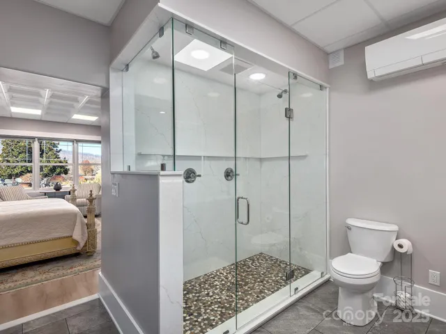 a bathroom with a toilet a sink and a shower