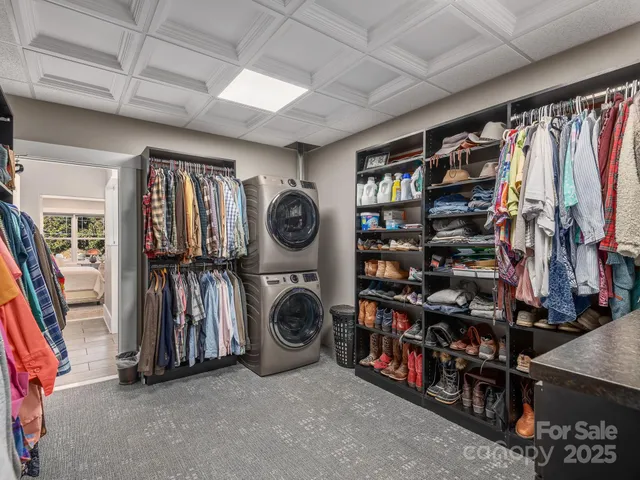 a view of walk in closet with clothes and shoes