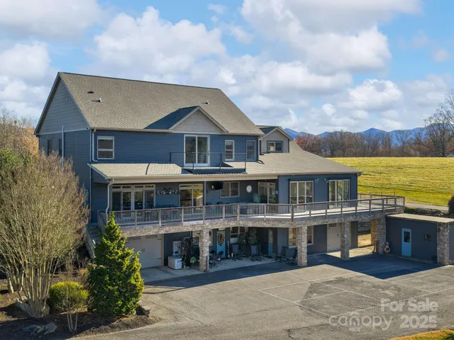 a front view of a house with a yard and lake view