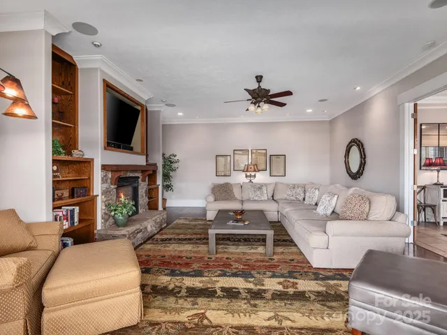 a living room with fireplace furniture and a flat screen tv