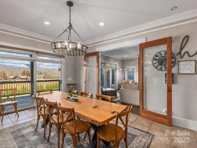 a dining room with furniture a chandelier and window