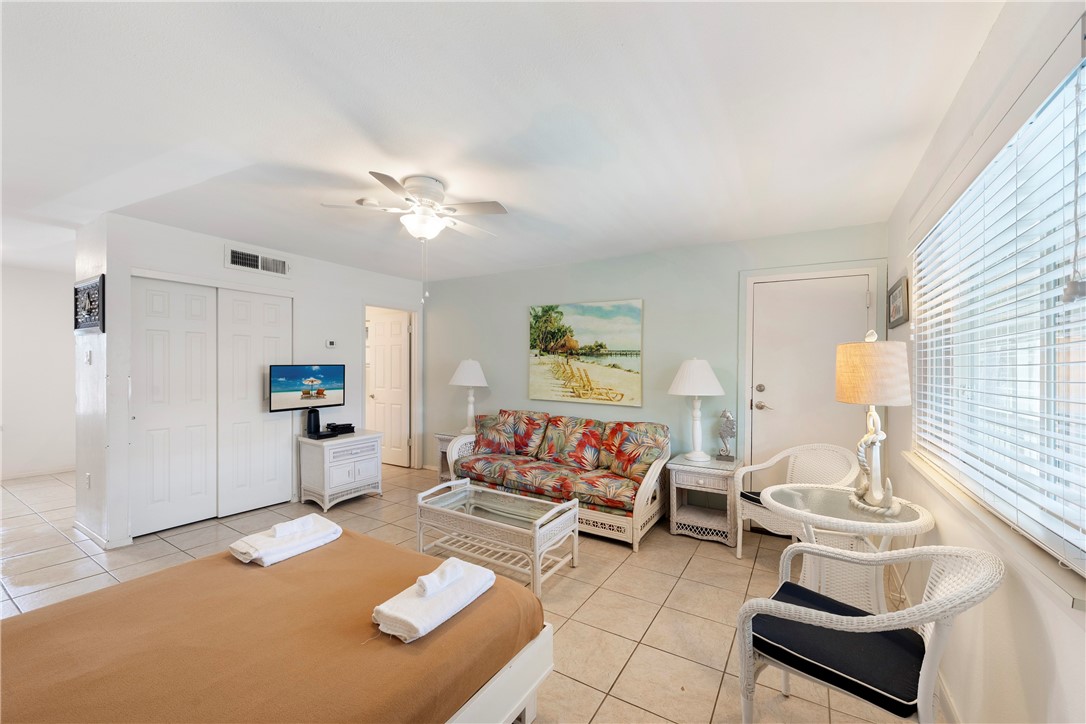 622 Beach Access Road, Unit 229 Port Aransas, TX 78373 - Photo 2 of 24 a living room with furniture and a table