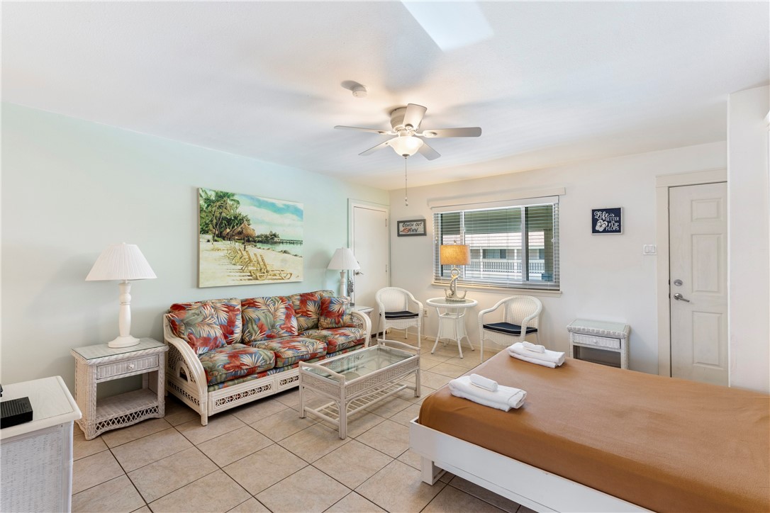 622 Beach Access Road, Unit 229 Port Aransas, TX 78373 - Photo 3 of 24 a living room with furniture and a table