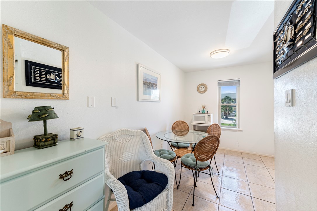 622 Beach Access Road, Unit 229 Port Aransas, TX 78373 - Photo 6 of 24 a kitchen with a dining table and chairs