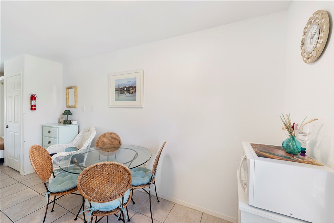 622 Beach Access Road, Unit 229 Port Aransas, TX 78373 - Photo 7 of 24 a view of a dining room with furniture and wooden floor