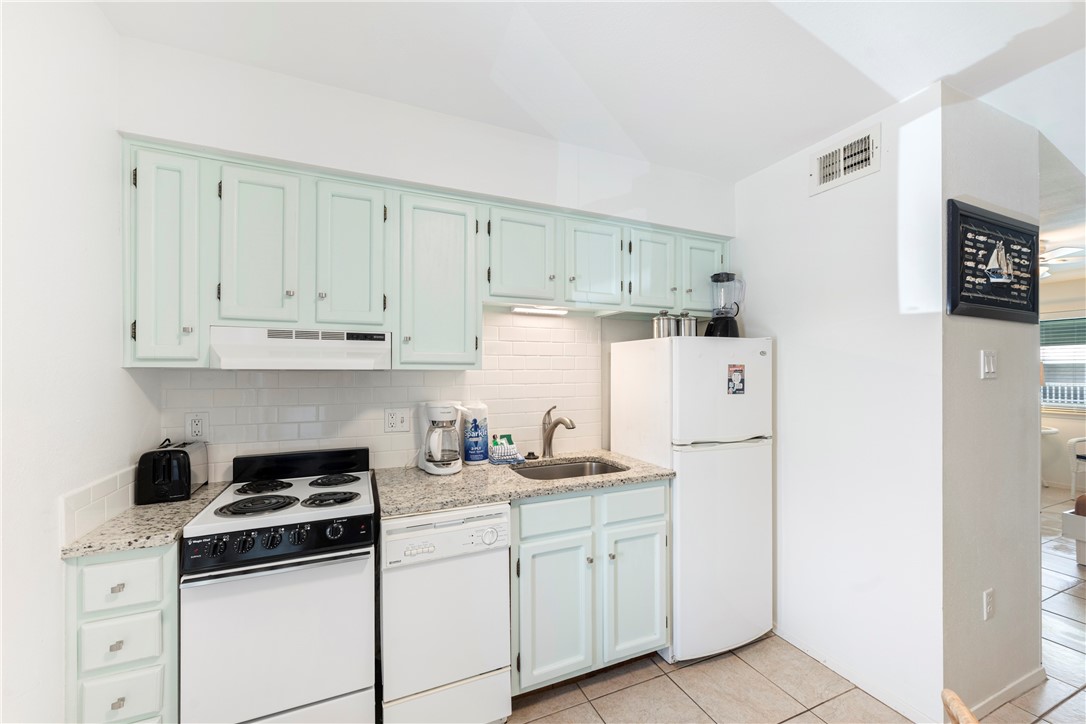 622 Beach Access Road, Unit 229 Port Aransas, TX 78373 - Photo 8 of 24 a kitchen with cabinets appliances and a sink