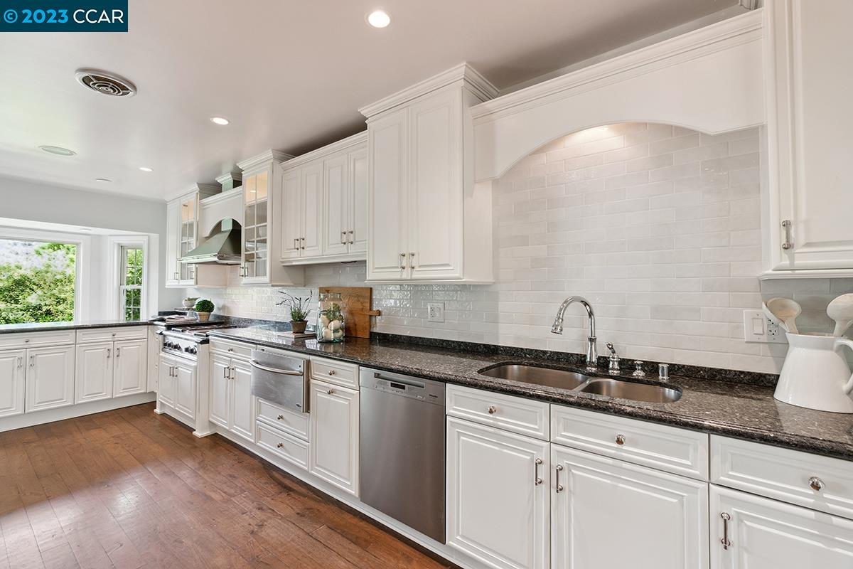Undisclosed Address Orinda, CA 94563 - Photo 17 of 53 a kitchen with granite countertop white cabinets and white appliances