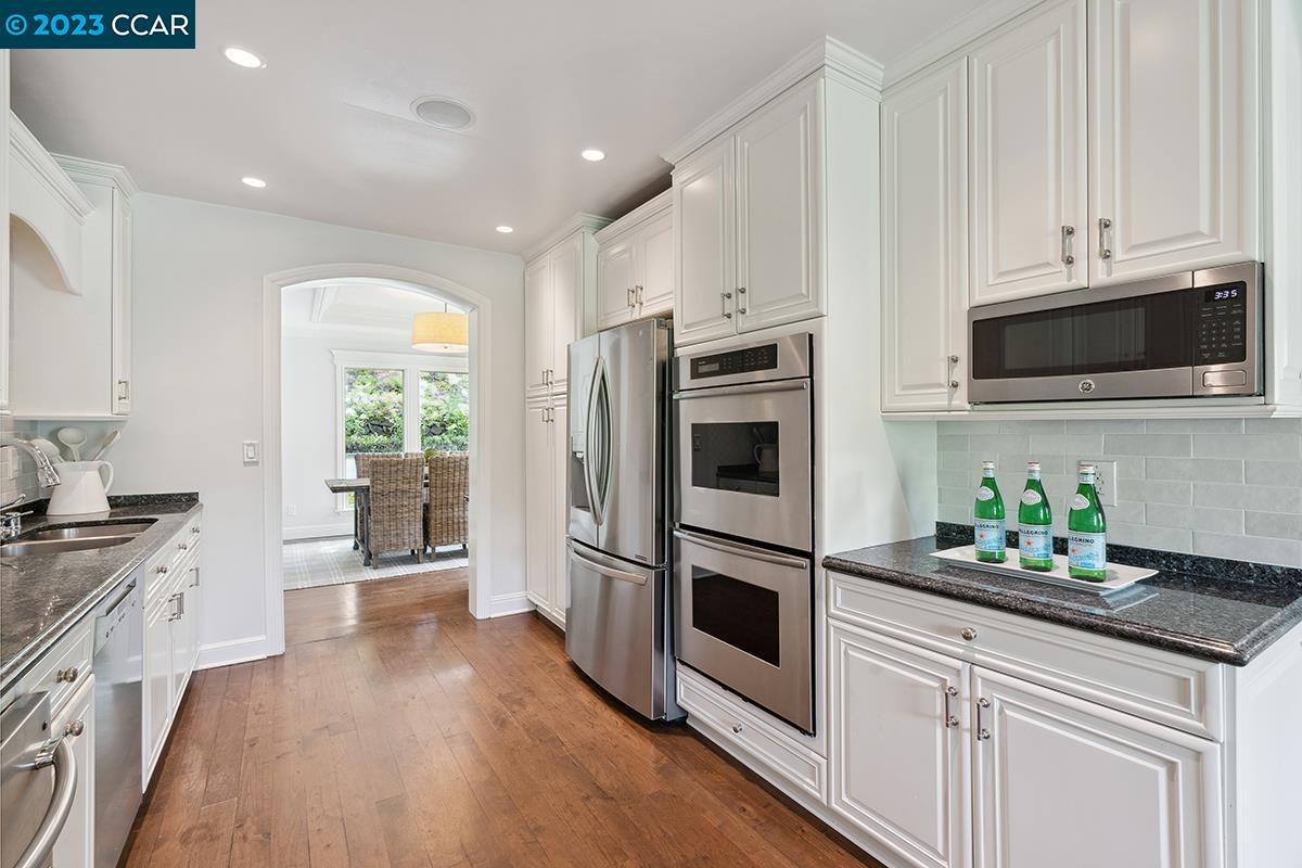 Undisclosed Address Orinda, CA 94563 - Photo 18 of 53 a kitchen with granite countertop a stove a sink and a microwave