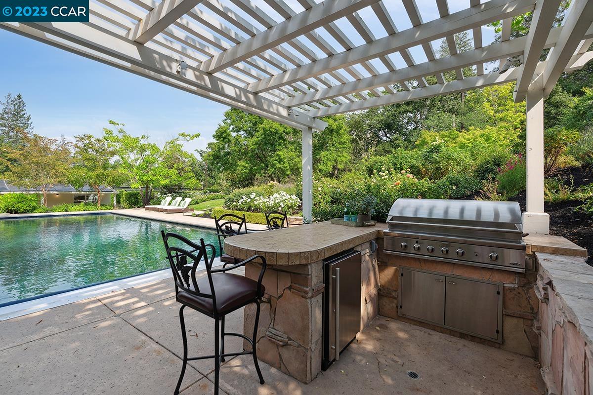 Undisclosed Address Orinda, CA 94563 - Photo 47 of 53 a patio with a table chairs and a barbeque