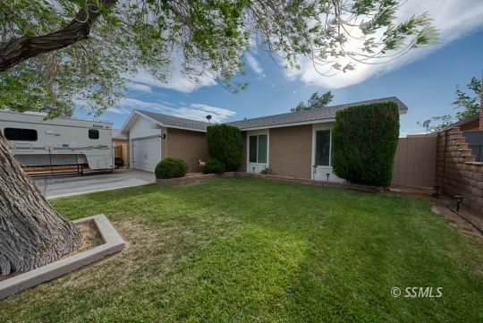 413 South Valley Street Ridgecrest, CA 93555 - Photo 35 of 40 a view of a house with backyard sitting area and garden