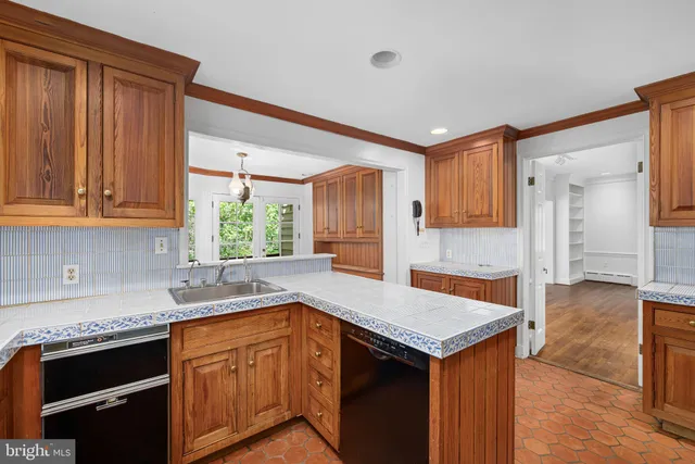 a kitchen with granite countertop a sink and a refrigerator