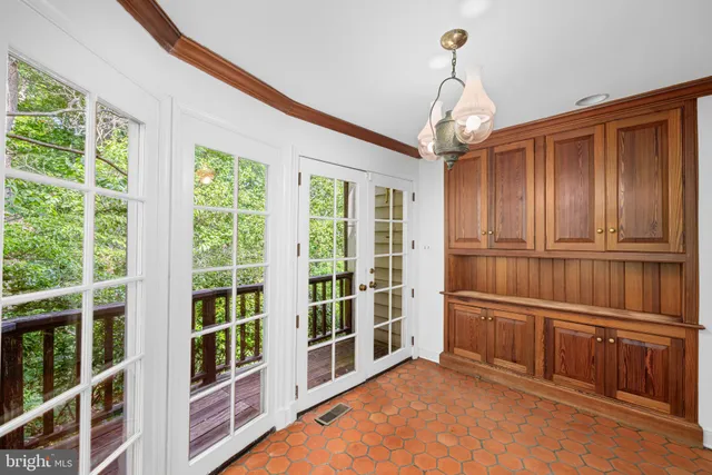 a view of empty room with wooden floor and windows