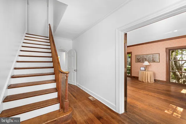 a view of a room with wooden floor and windows