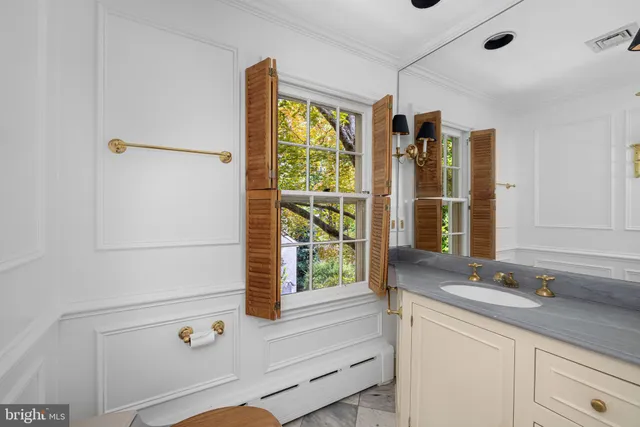 a bathroom with a sink and a large mirror