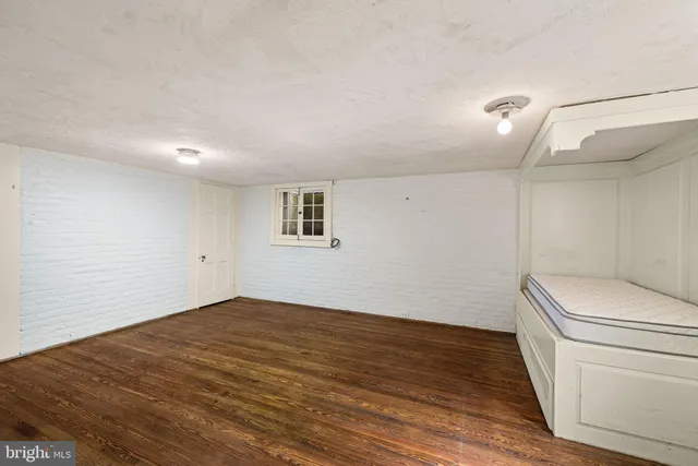 a view of a room with wooden floor and window