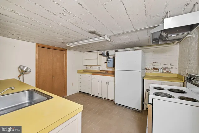 a kitchen with a refrigerator sink stove and cabinets