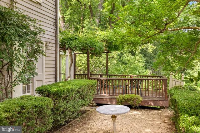 a view of a chair and table in backyard