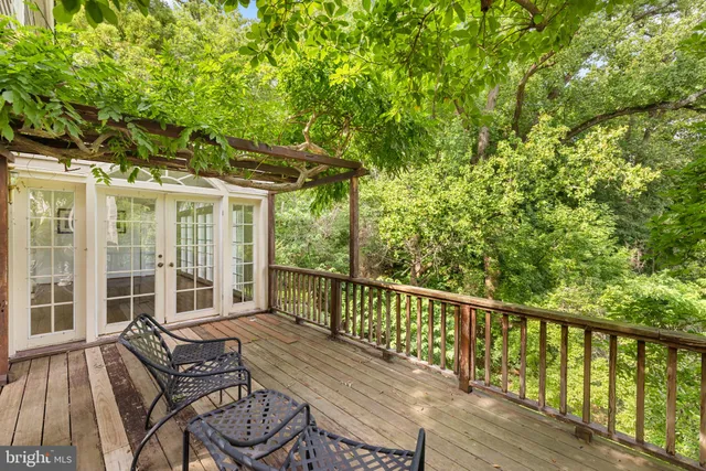 a balcony with wooden floor and furniture