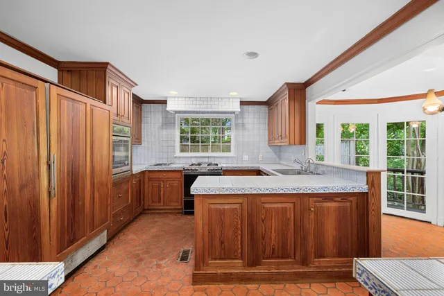 a kitchen with a stove and a window